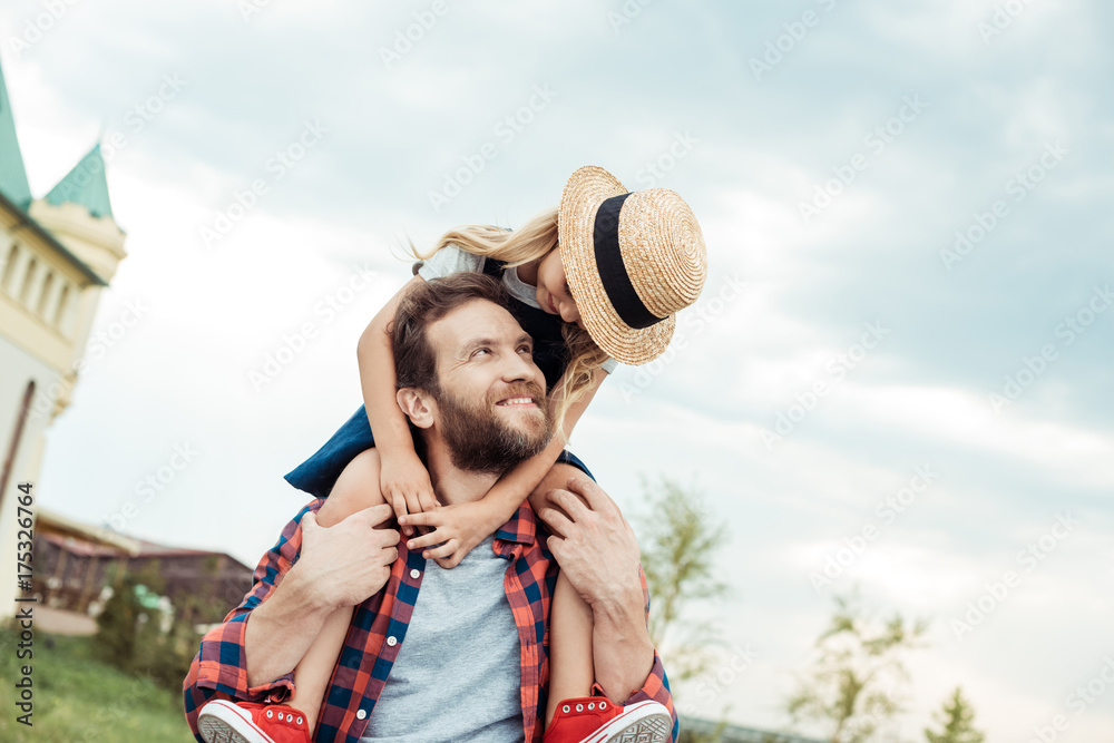 father and daughter piggybacking together