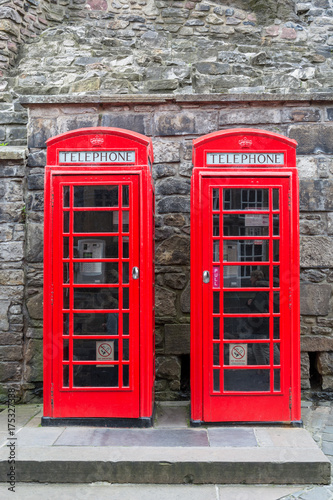Two red british telephone boxes from the front