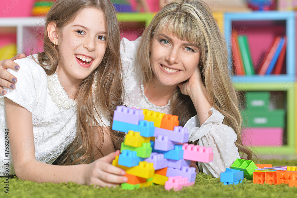 Happy mother playing with her daughter in the designer Happy mother playing with her daughter in the designer