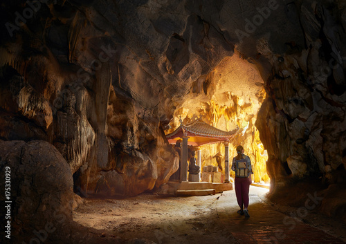 Tourist looking at cave with Thong pagoda in Tam Coc Bich Dong. Ninh Binh, Vietnam. photo