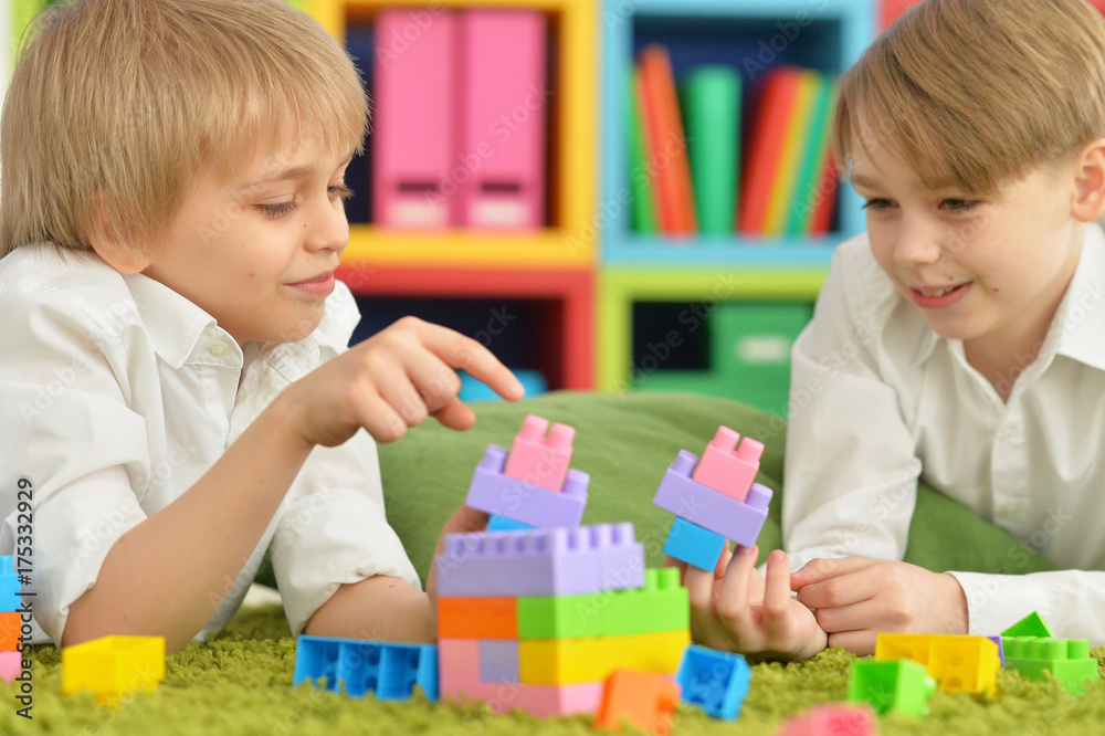 boys playing with colorful plastic blocks boys playing with colorful plastic blocks
