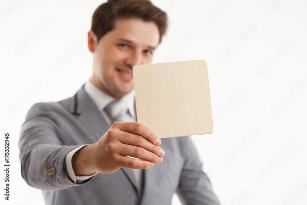 Young businessman showing signboard, isolated on white.