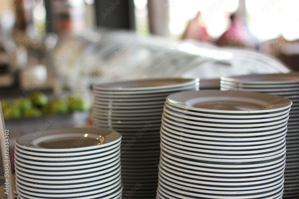 Piles of white plates in a restaurant Piles of white plates in a restaurant