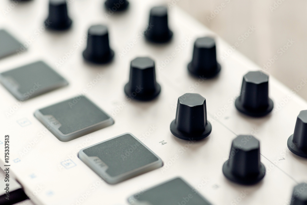 MIDI keyboard with pads and faders.