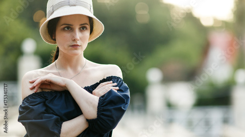 Picture of brunette in hat at park
