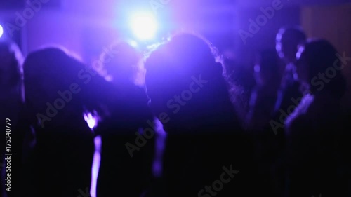 Dancing silhouettes of young woman in a nightclub photo