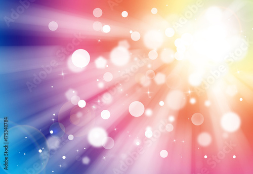 Colorful glitter sparkles rays lights bokeh festive elegant abstract background.