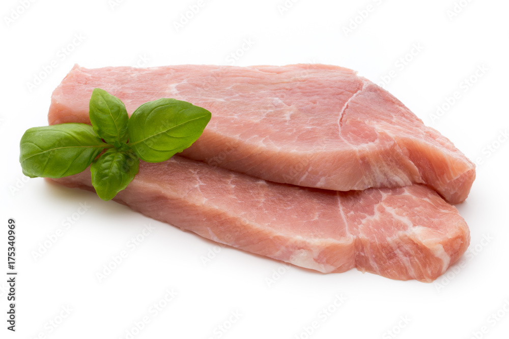 Fresh pork fillet with basil on a white background.