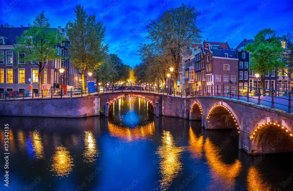 Bridge Blue hour arch over canal in Amsterdam Netherlands.