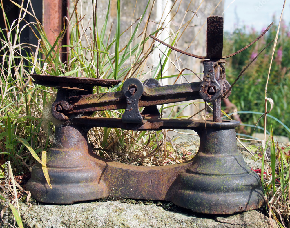 rusty iron weighing scales in a rural setting outdoors rusty iron weighing scales in a rural setting outdoors