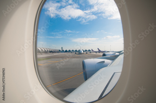 Airplane on runway prepare for take off from window view.