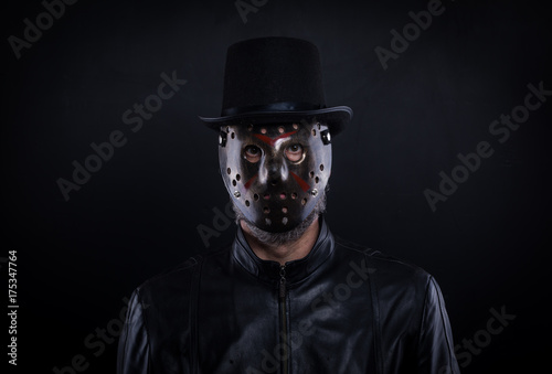 Mystery man holding black mask. Anonymous social masking concept.