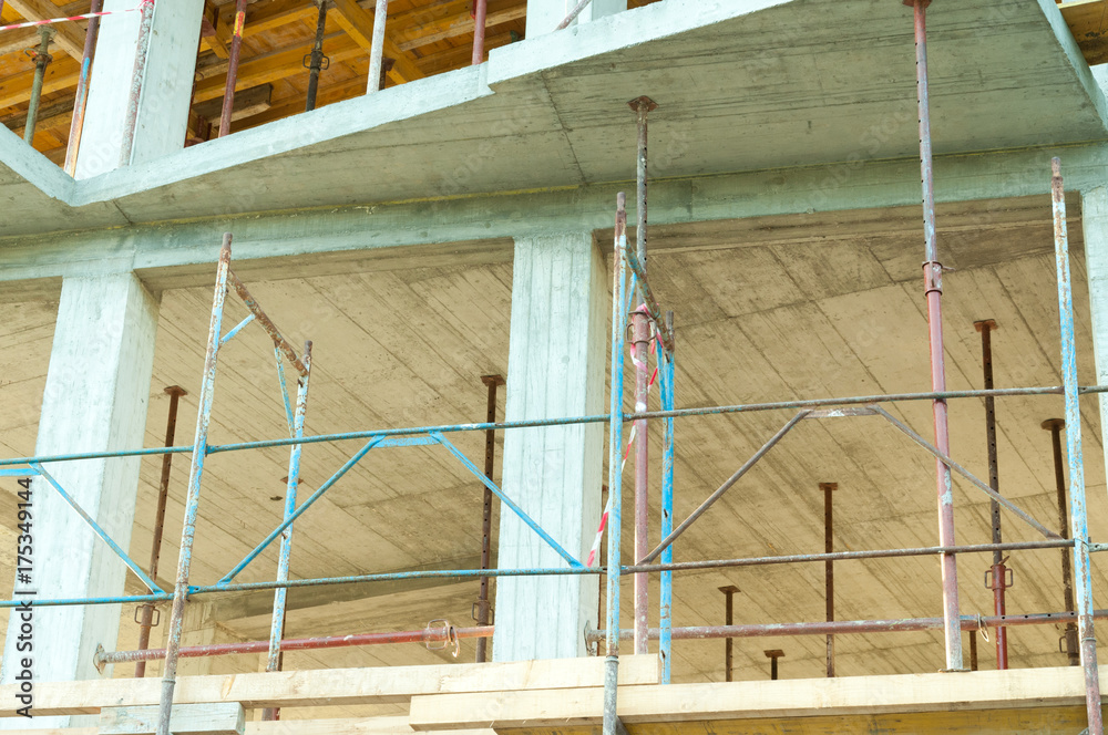 Scaffolds on the new building construction site closeup Scaffolds on the new building construction site closeup