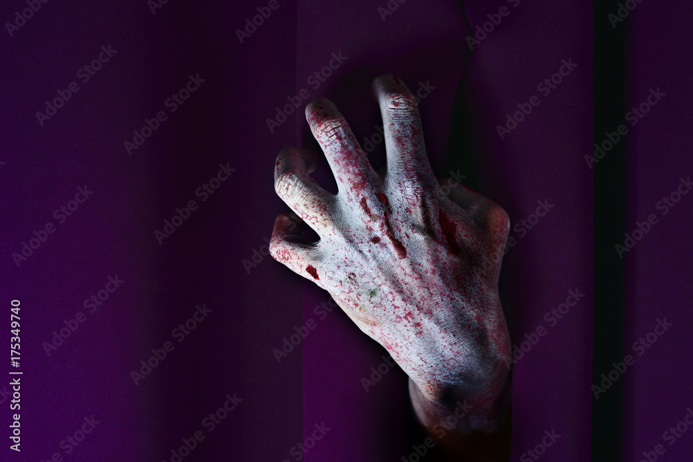 zombie hand coming out from behind a stage curtain