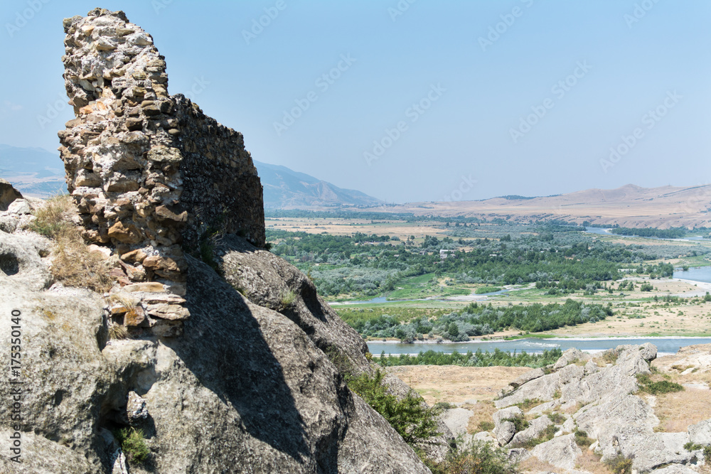 Imposing rocks of old religious town Uplistsikhe and  valley of Kura river, Georgia