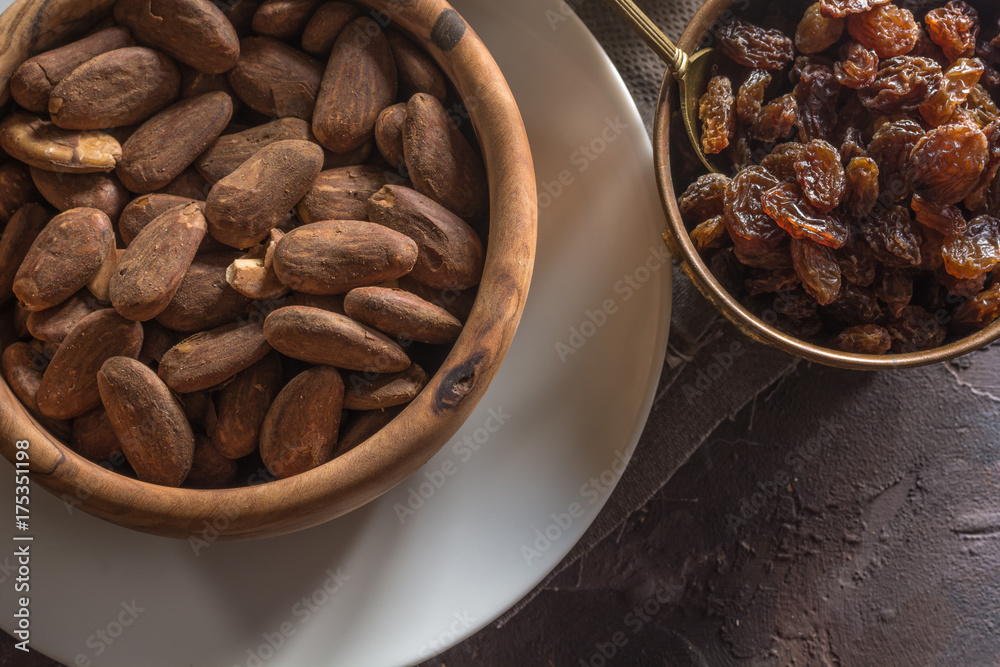 Almond with raisins in a dish of wood Almond with raisins in a dish of wood