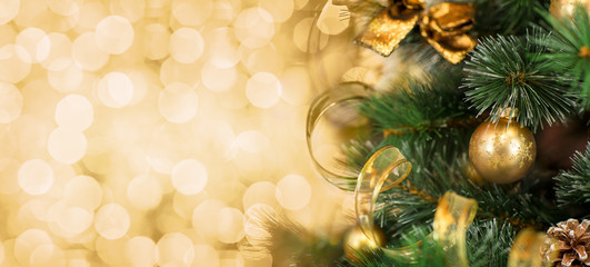 Christmas tree branch with blurred golden background