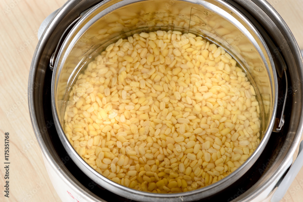 mung bean in electric pot on wooden table mung bean in electric pot on wooden table