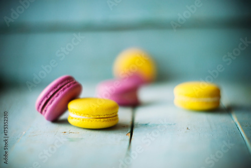 Group of pastel color macaroons on blue textured shabby chic background, with room for copy space