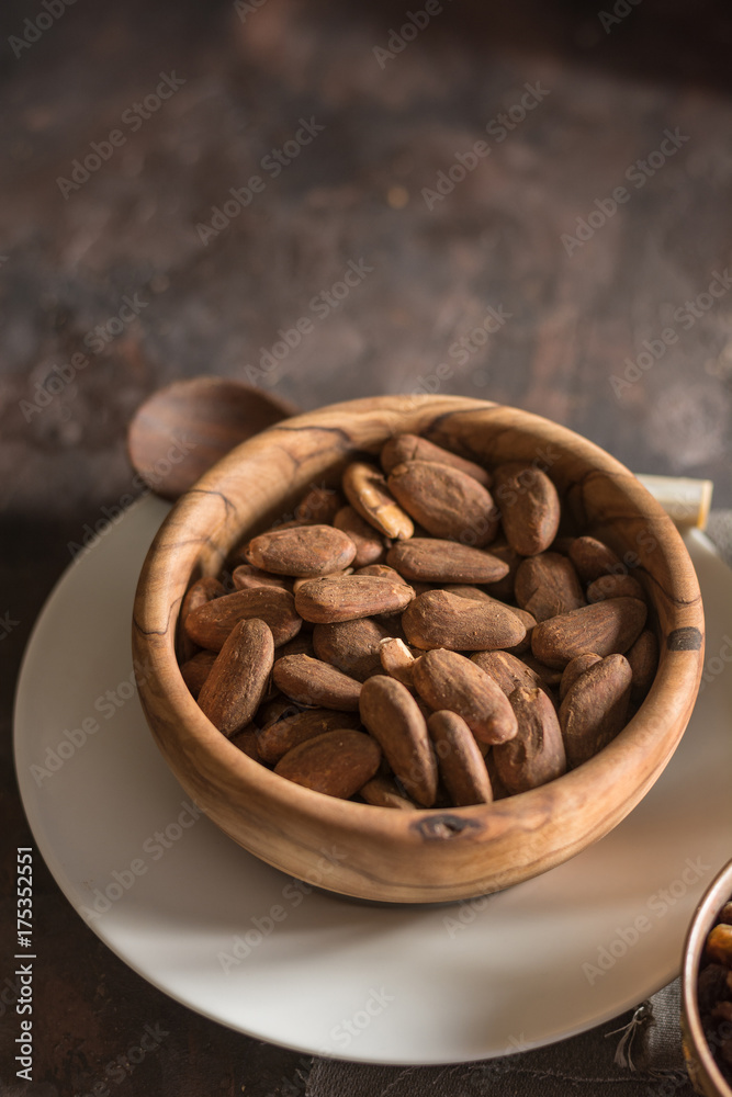 Almond with raisins in a dish of wood Almond with raisins in a dish of wood