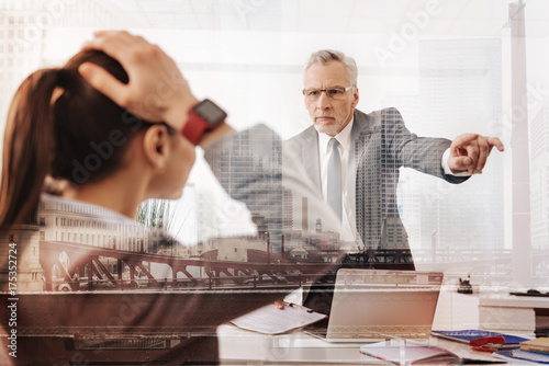 Strict professional boss dismissing a female office worker