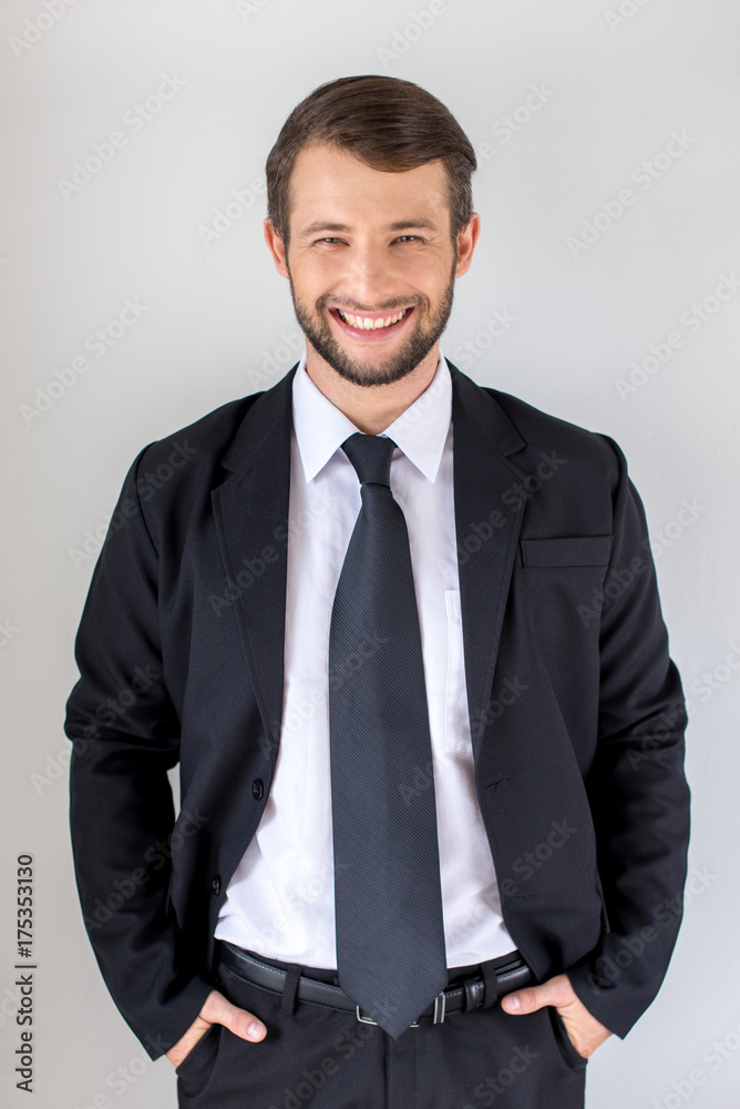Young man wearing a suit and smiling Young man wearing a suit and smiling