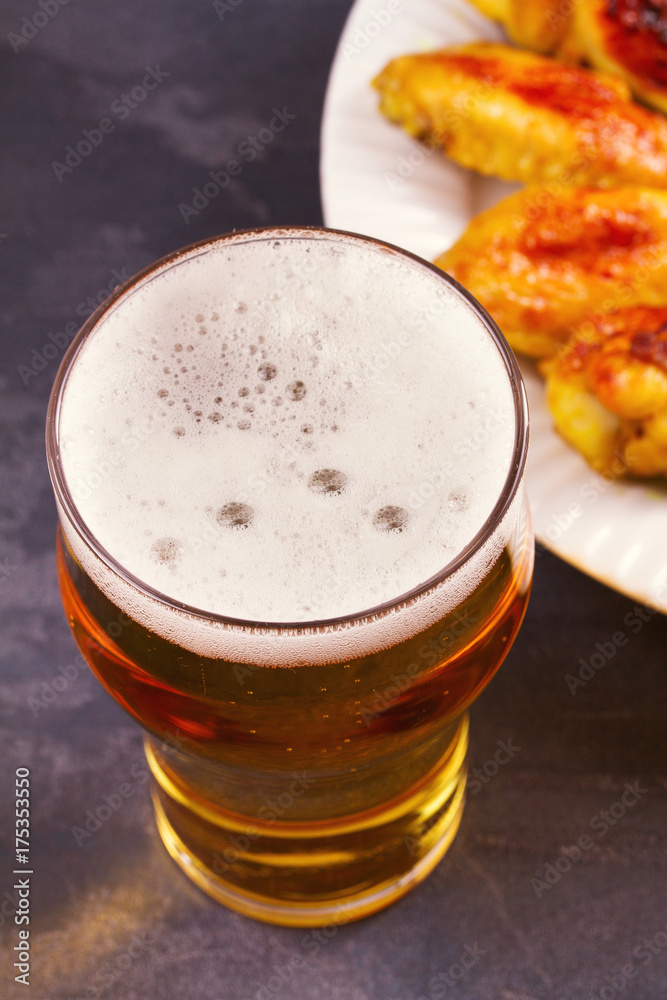 Beer and chicken wings buffalo with cheese dip. View from above, top studio shot, vertical Beer and chicken wings buffalo with cheese dip. View from above, top studio shot, vertical