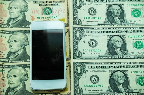 Wallpaper Mural Mobile smartphone on US dollar banknote, digital money concept Torontodigital.ca