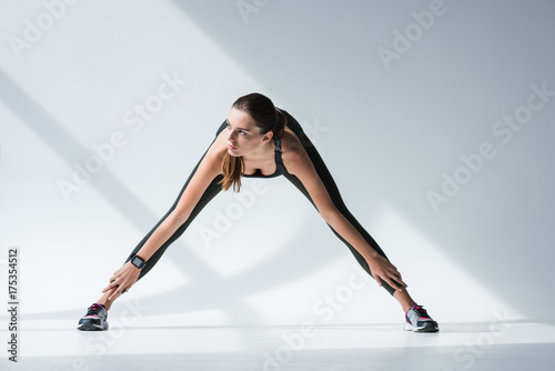 sporty woman stretching legs