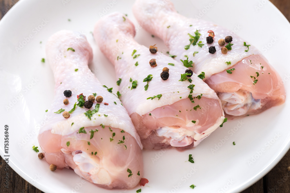 raw drumstick chicken on white plate
raw drumstick chicken on white plate