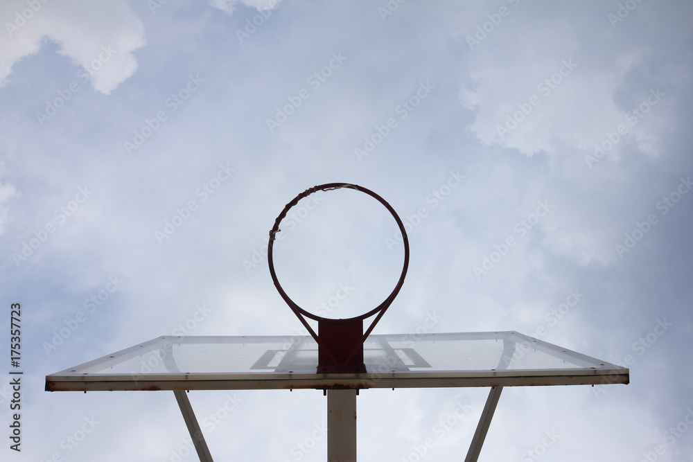 Basketball basket with transparent backboard on beautiful sky Basketball basket with transparent backboard on beautiful sky