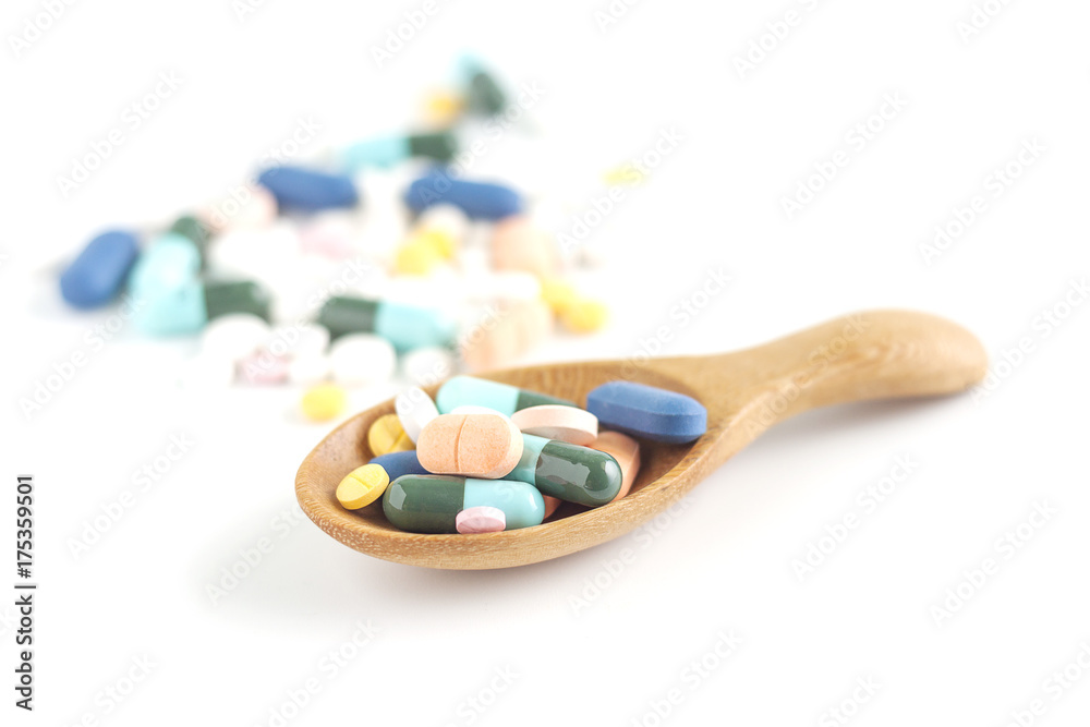 Colorful medicine on wooden spoon Colorful medicine on wooden spoon