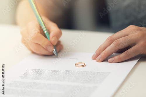 woman signing marriage divorce papers photo