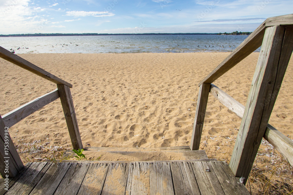 Stairs To The Beach Background. Wooden stairs lead to a wide sandy