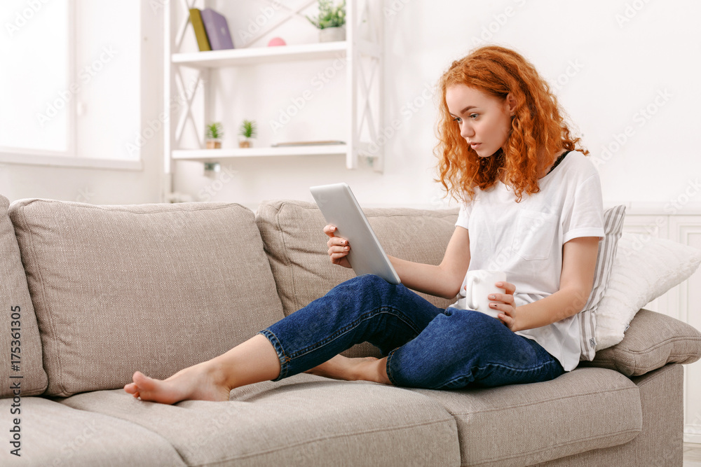 Young girl with a tablet at home