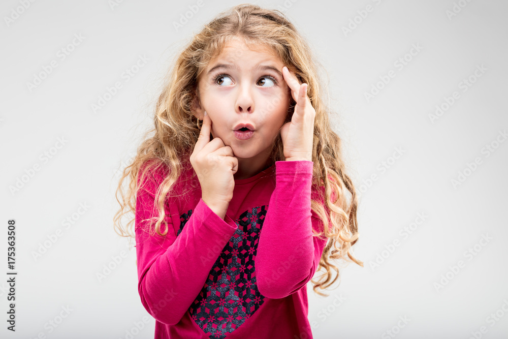 Fun playful little girl with a teasing expression Fun playful little girl with a teasing expression