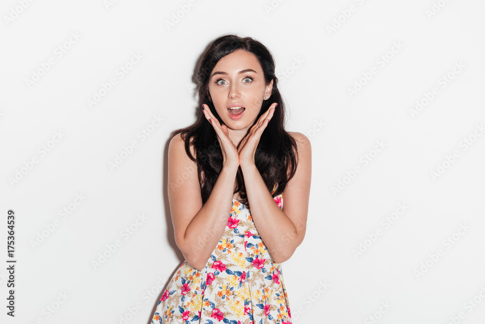Surprised brunette woman posing in studio and looking at camera Surprised brunette woman posing in studio and looking at camera