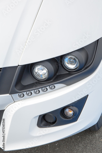 headlight of new prestigious car close up. All LED adaptive headlight of a modern car. Garage theme