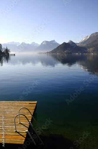 Fototapeta Naklejka Na Ścianę i Meble -  Annecy lake from Talloires and wooden pontoon, winter landscape,