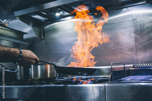 Quadro su tela Chef cook with frying pan