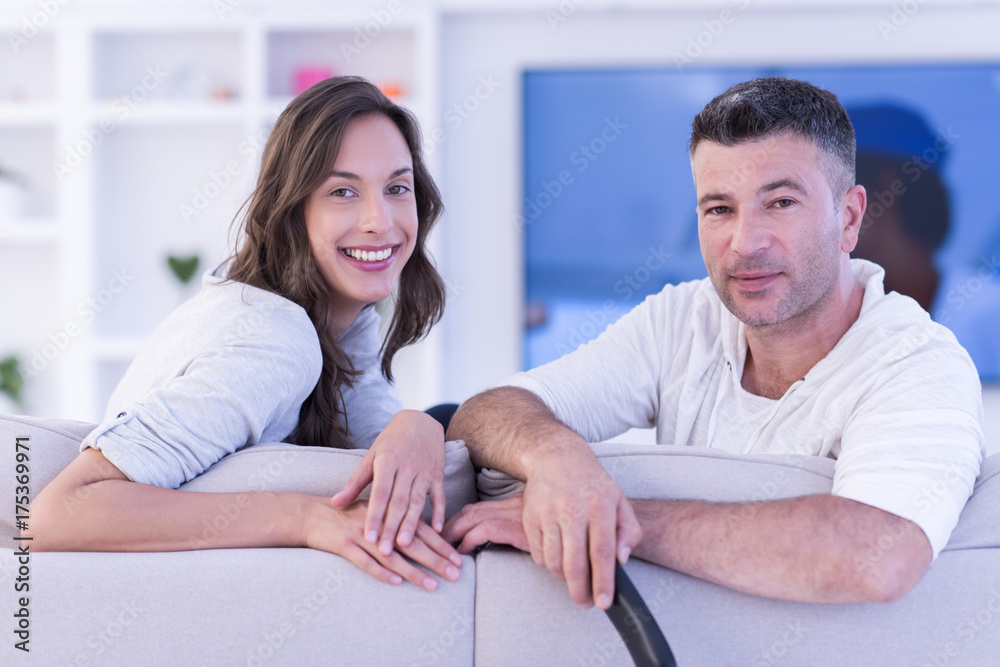 Young couple on the sofa watching television Young couple on the sofa watching television
