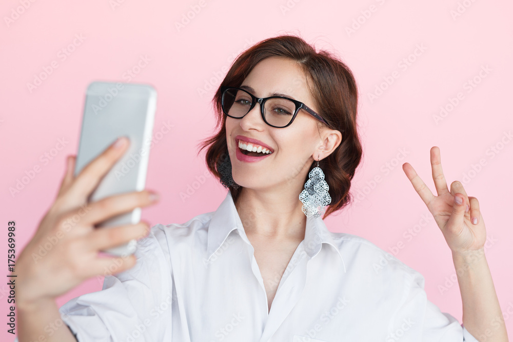 Smiling woman making selfie with smartphone Smiling woman making selfie with smartphone