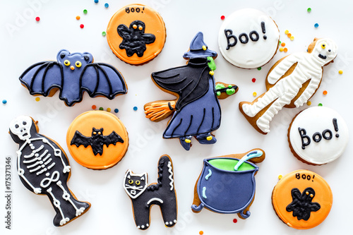 Bright halloween gingerbread cookies background with bat, witch, skeleton, ghost on white background top view