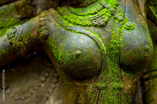 Statue of Goddess naked chest There are green moss on the body.
