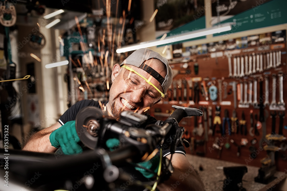 Bicycle mechanic in a workshop in the repair process