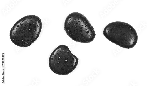 Black spa stones with water drops isolated on white background, top view