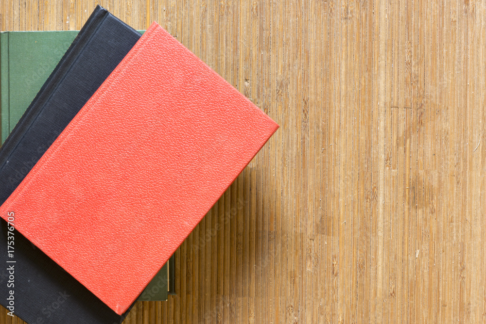 Fototapeta premium Several books on a mat of a brown color