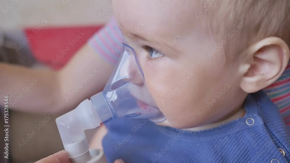 Treatment of lung disease with an inhaler. A little boy in the mask of an inhaler. Treatment at home. Treatment of lung disease with an inhaler. A little boy in the mask of an inhaler. Treatment at home.