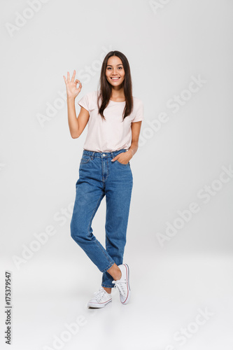 Full length portrait of a cheerful young asian woman