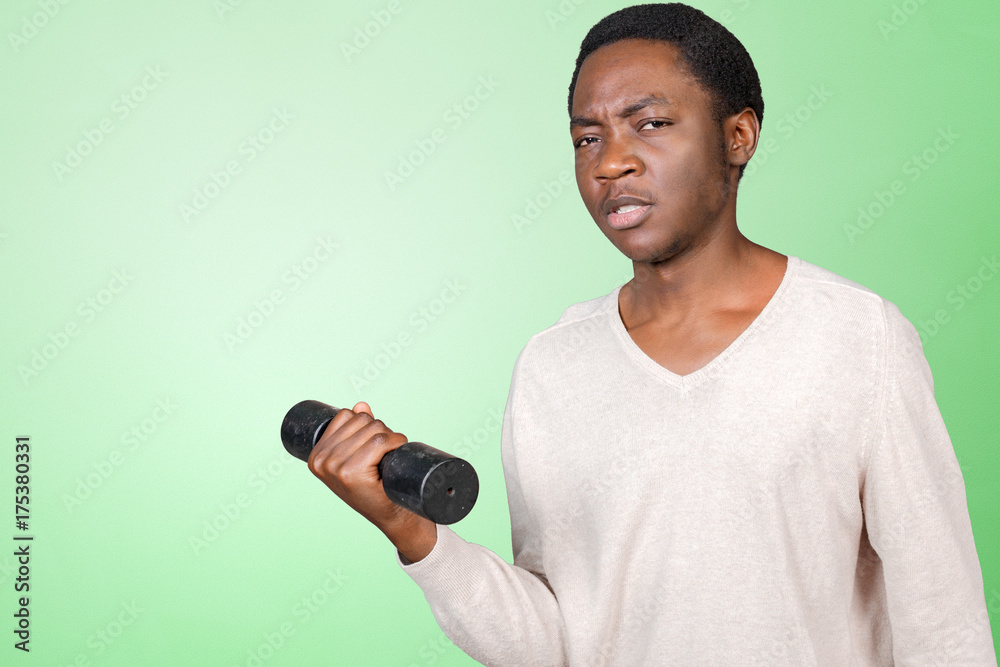 Funny weak african american man tries to lift a weight Funny weak african american man tries to lift a weight